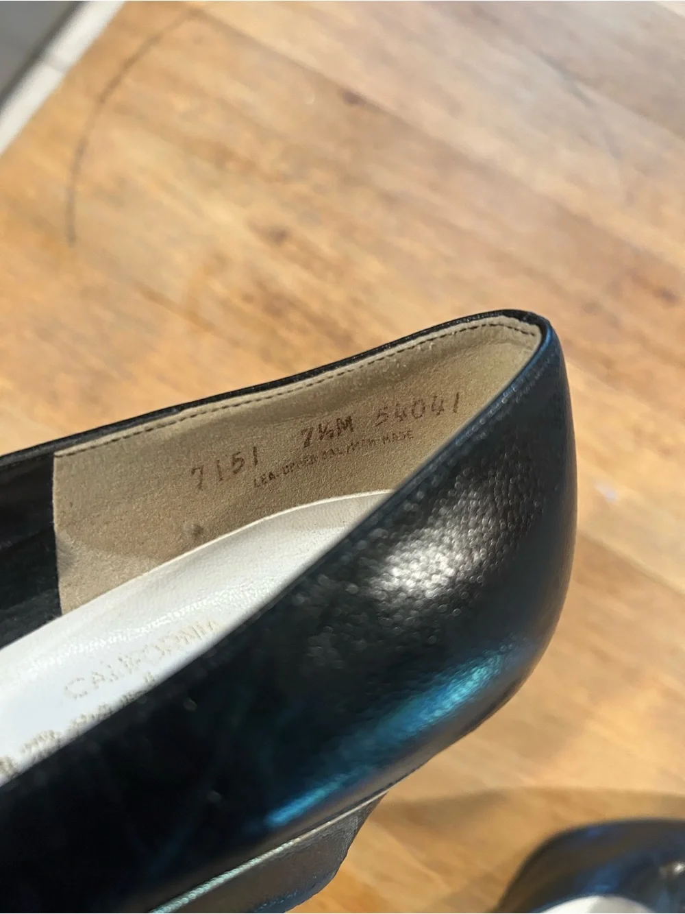 Black Leather Pointed-Toe Wedge Pumps